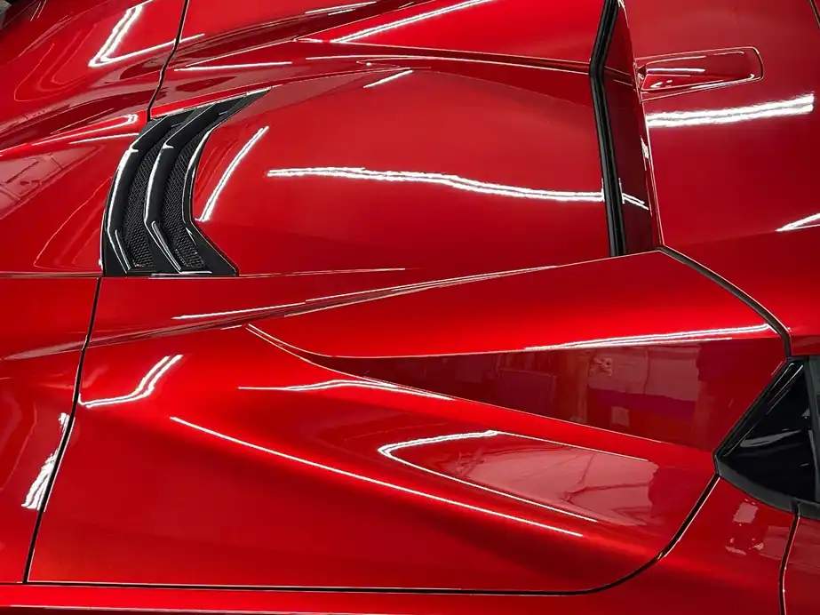 Coated red Corvette quarter panel with a mirror gloss