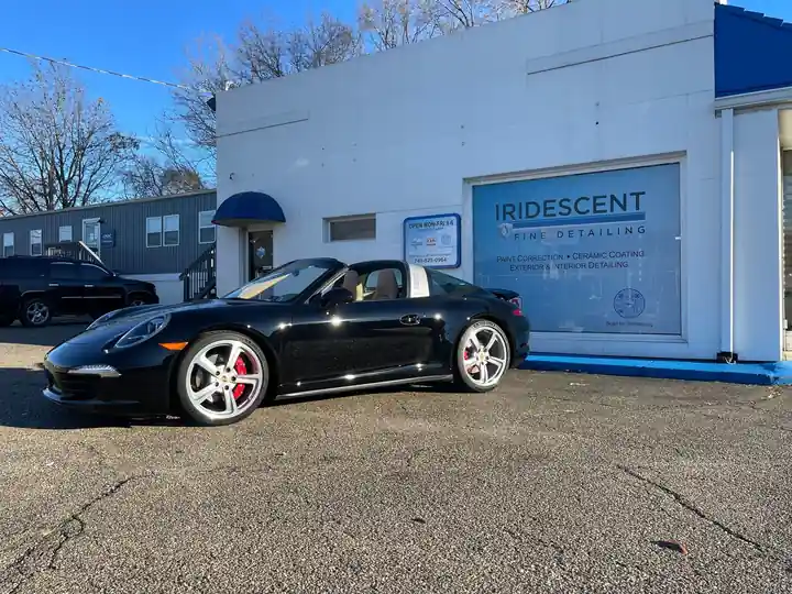 Black Porsche 911 Targa in front of the shop