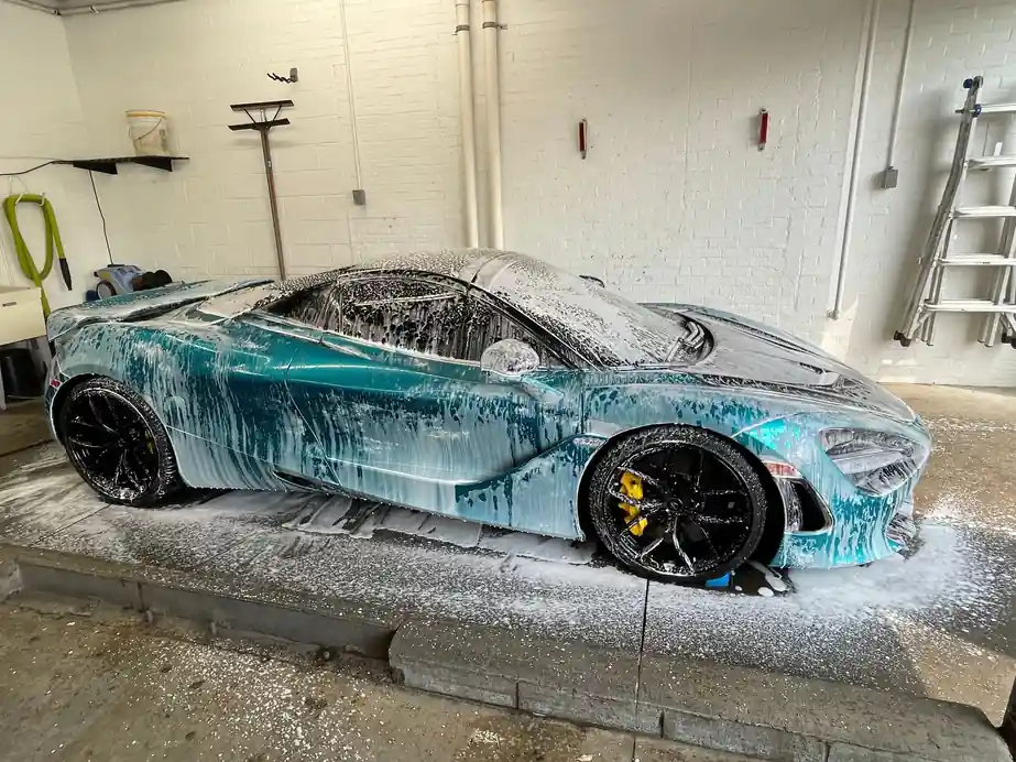McLaren 720S covered in wash foam in the detailing bay